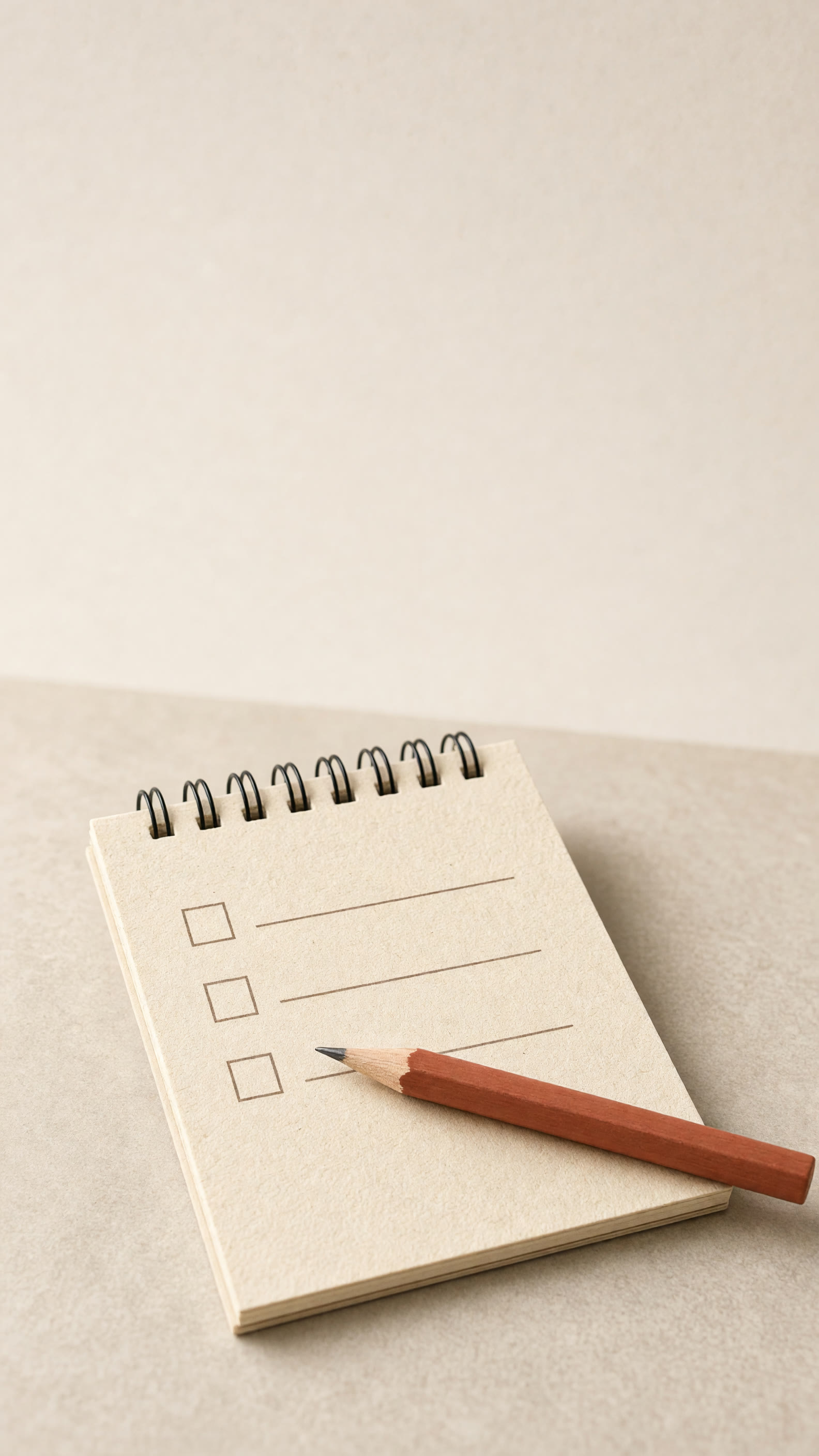 cream checklist notepad with three empty boxes